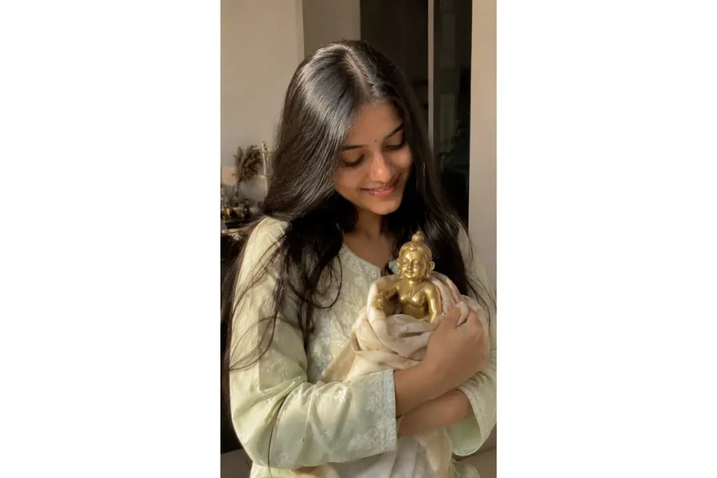 Radharani holding a small krishna idol in her arms