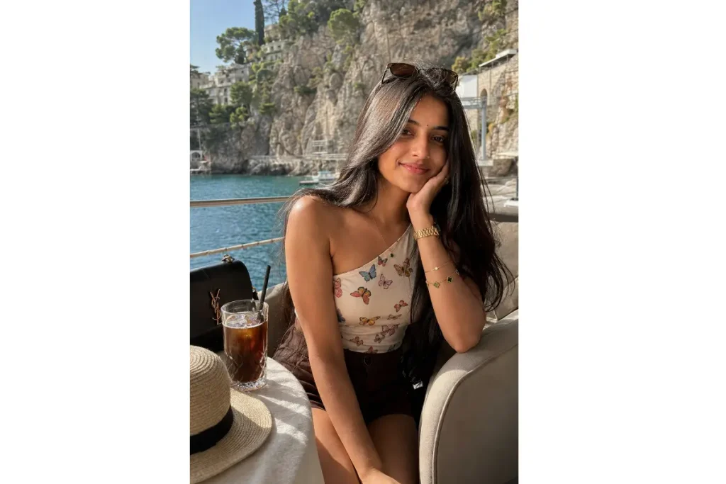 Realistic AI portrait of a woman at a seaside cafe with turquoise water