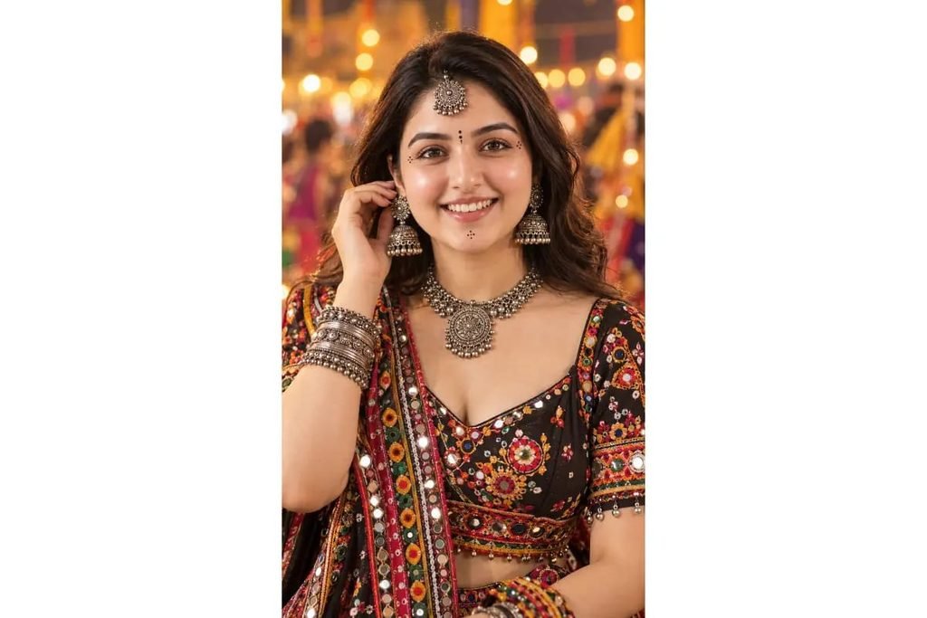 Gujarati Garba girl in a black colorful mirror-work chaniya choli with oxidized silver jewelry, jhumka earrings and traditional maang tikka for Navratri