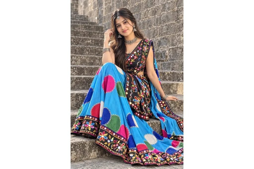 SEO-Friendly Alt Text: Black Gujarati Navratri lehenga choli with colorful mirror work, sky-blue dupatta and vibrant embroidered skirt for girls’ Garba outfit inspiration