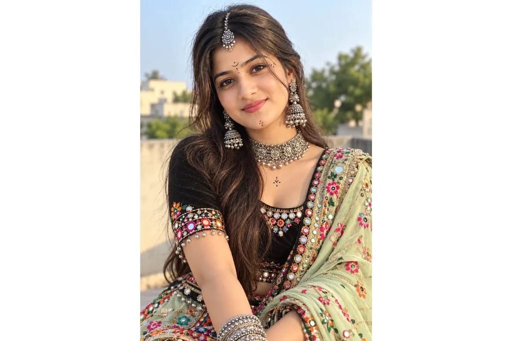 Gujarati Garba girl wearing a black mirror-work choli with a pastel embroidered dupatta, traditional silver jewelry and maang tikka for Navratri