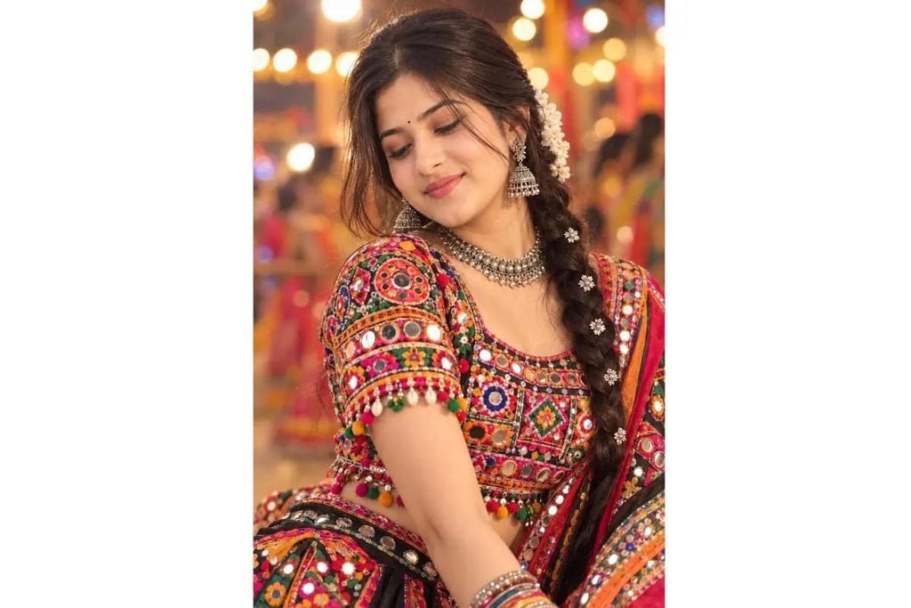 Gujarati Garba girl in colorful mirror-work chaniya choli with traditional jewelry and braided hairstyle for Navratri