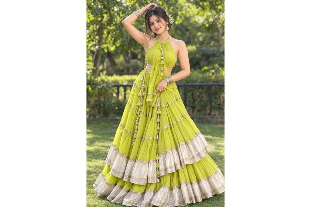 SEO-Friendly Alt Text: Lime yellow-green Navratri lehenga gown with elegant silver embroidered borders, traditional Gujarati festive outfit for girls in a garden photoshoot