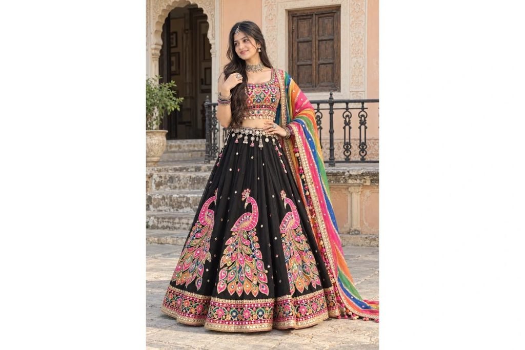 SEO-Friendly Alt Text: Black Gujarati Navratri lehenga choli with intricate pink peacock embroidery and colorful rainbow dupatta, traditional Indian Garba outfit for girls’ photoshoot